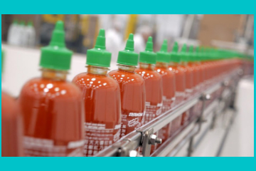 Full Sriracha bottles